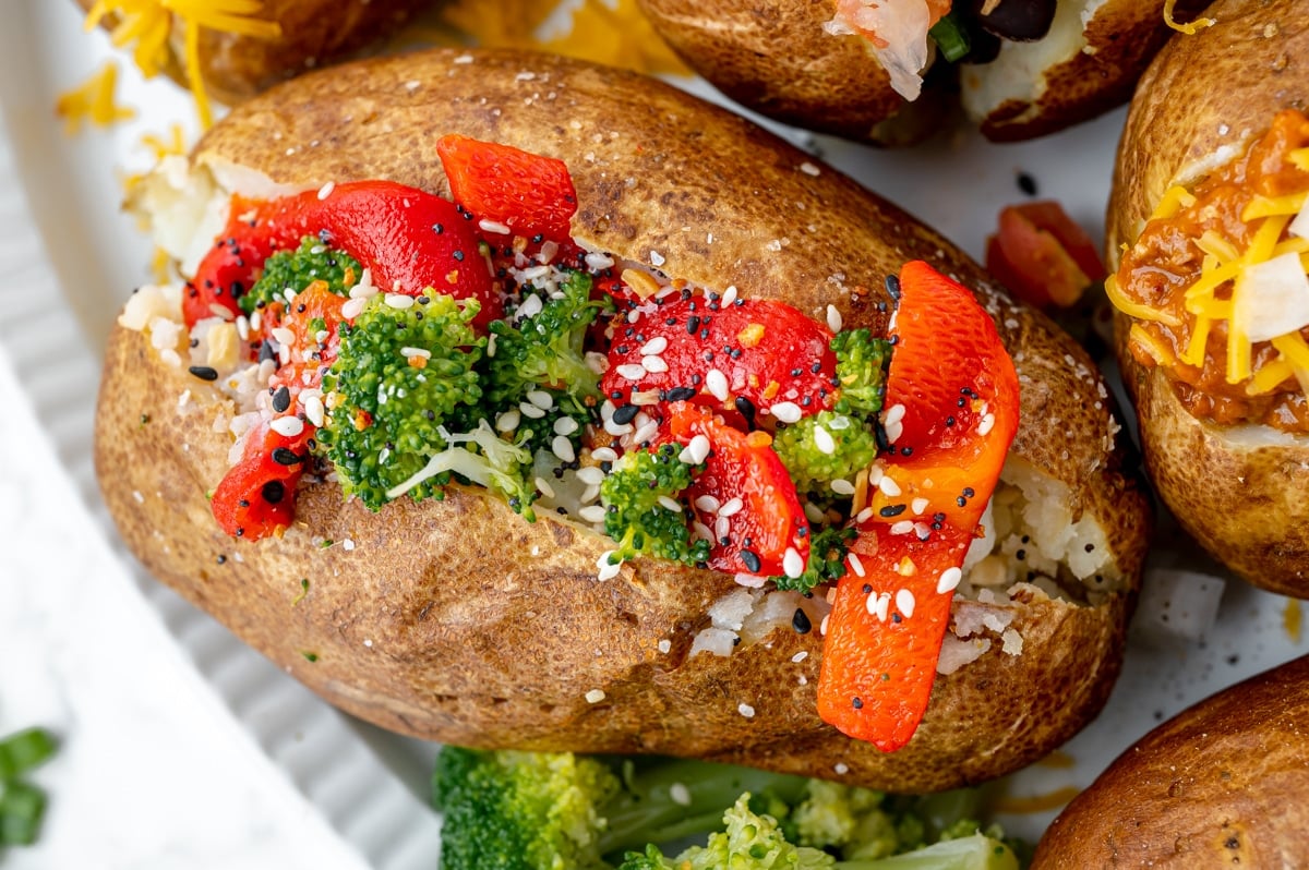 overhead shot of baked potato topped with broccoli and peppers