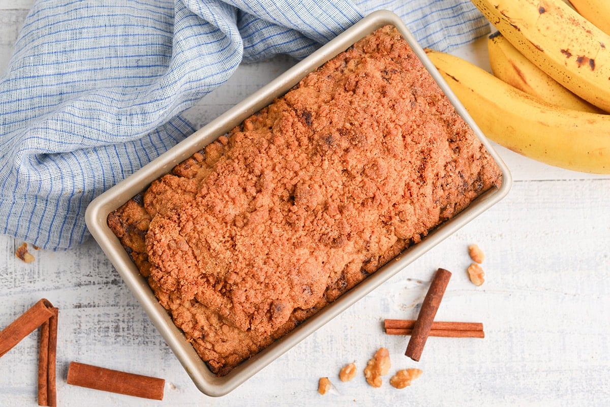 overhead of baked banana bread with streusel topping in loaf pan