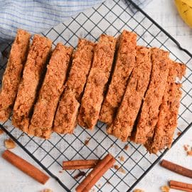 sliced banana nut bread with streusel topping on a wire rack