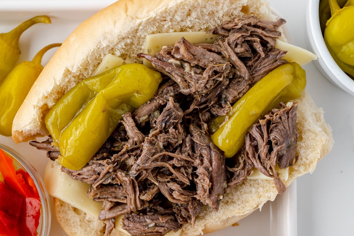 overhead shot of shredded italian beef on bun