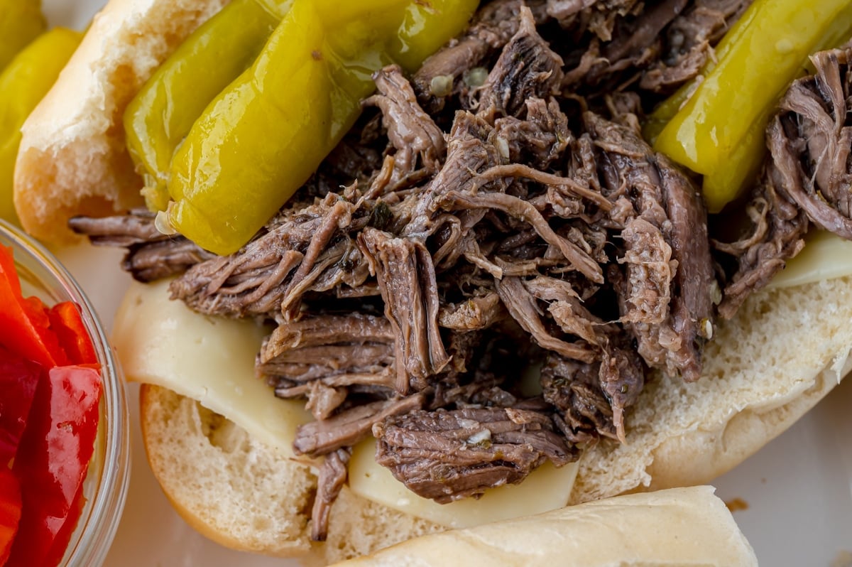 close up of shredded beef on bun