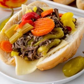 angled shot of italian beef sandwich on plate