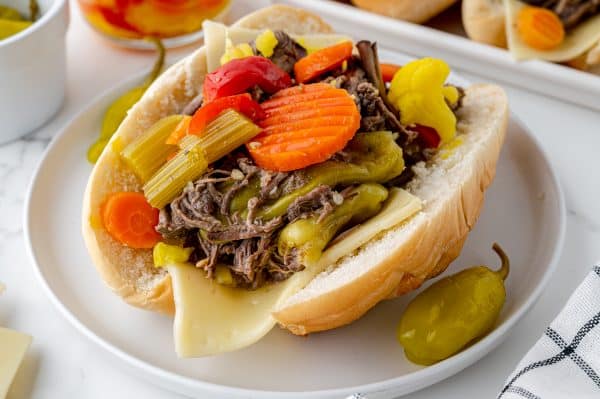 angled shot of italian beef sandwich on plate