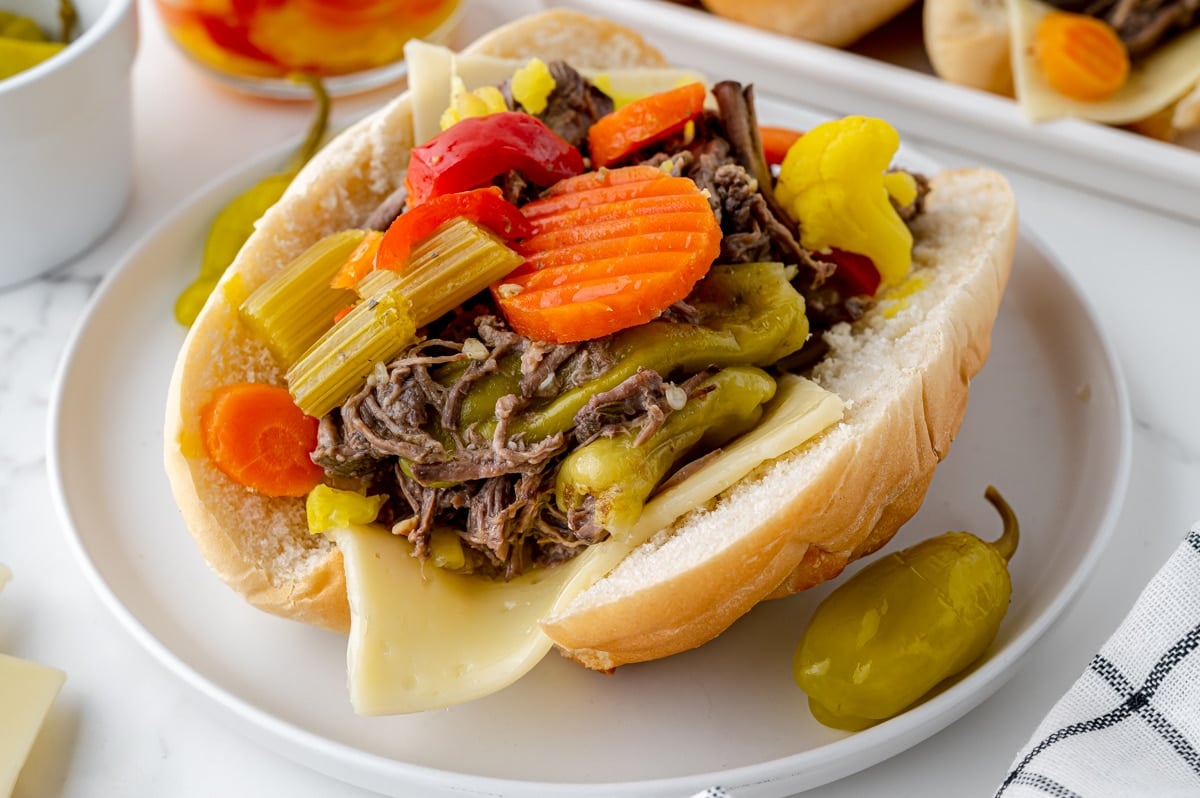 angled shot of italian beef sandwich on plate