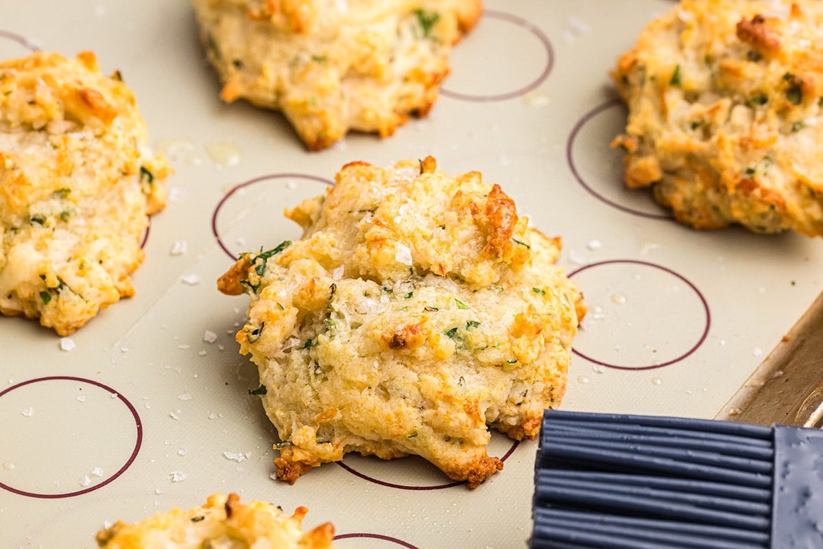 angled shot of cheese herb biscuits on sheet pan