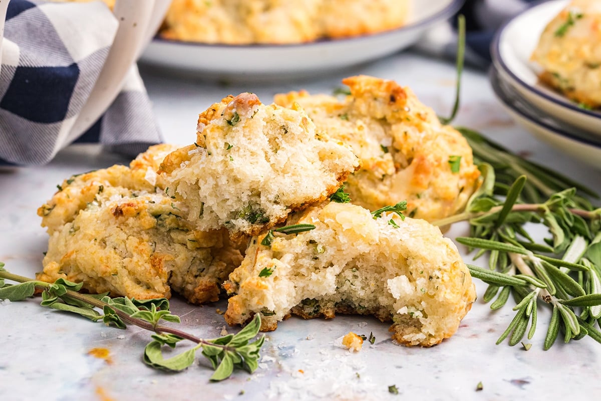 close up of bite taken out of cheesy herb drop biscuits