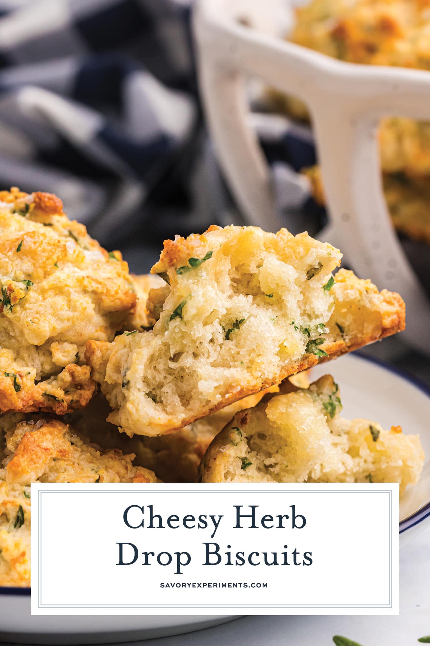 cheesy herb biscuit cut in half with text overlay for pinterest