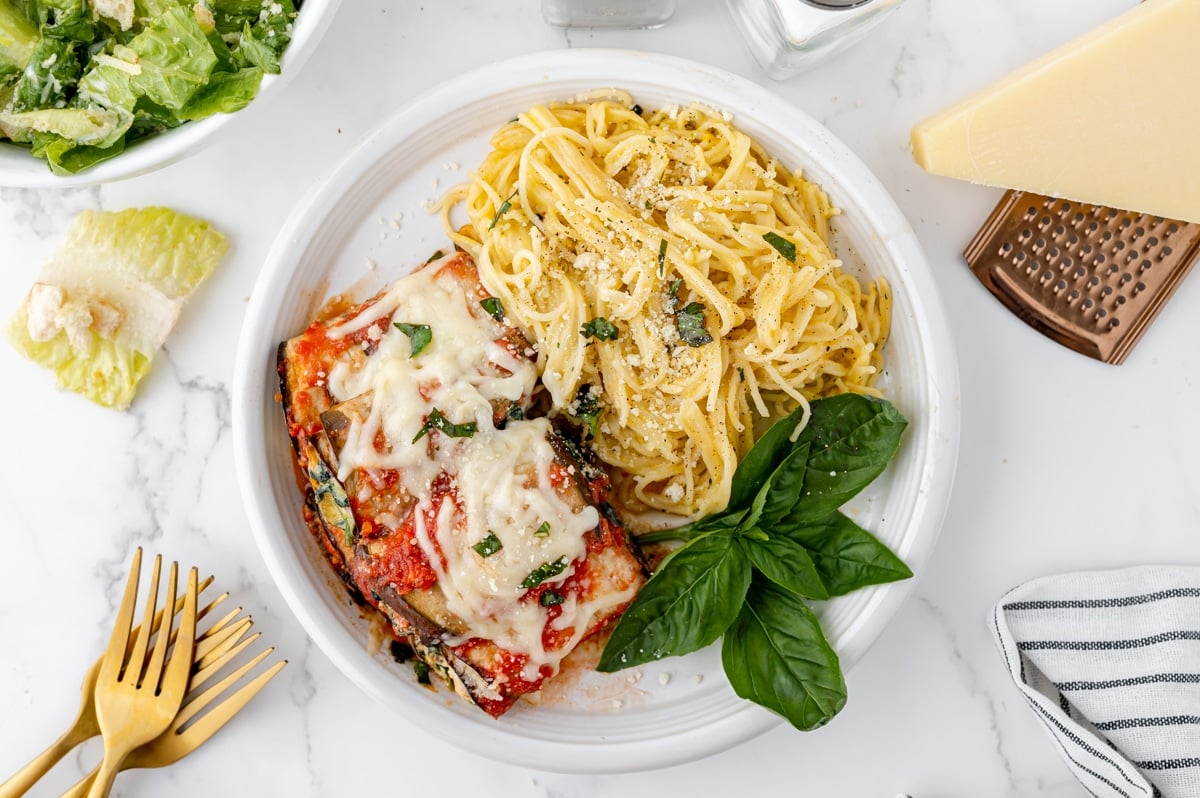 overhead shot of eggplant rollatini on plate with pasta