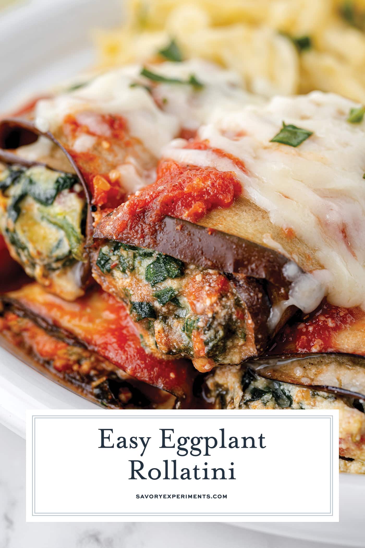 angled shot of stacked eggplant rollatini with text overlay for pinterest