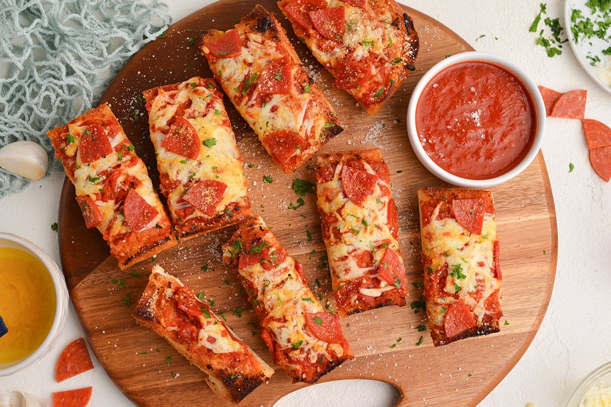 overhead shot of slices of french bread pizza on wooden board