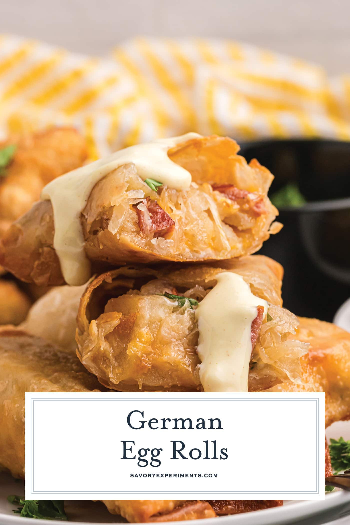 stack of german egg rolls with sauce with text overlay for pinterest