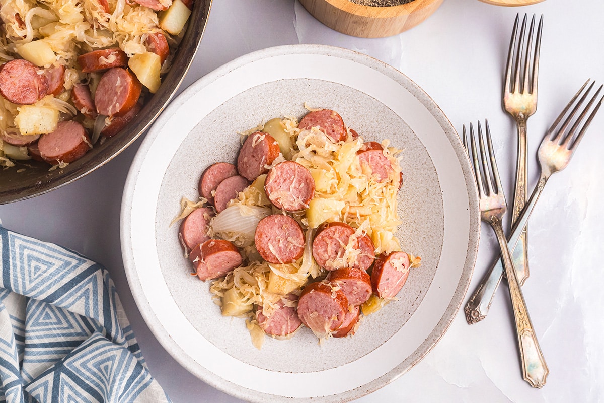 overhead shot of pork and sauerkraut on a plate with three forks