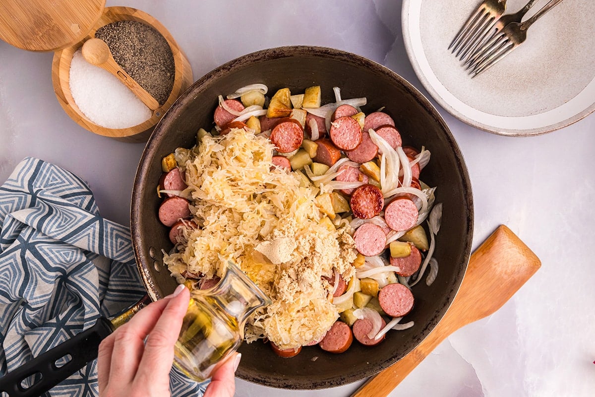 sauerkraut and seasoning added to skillet