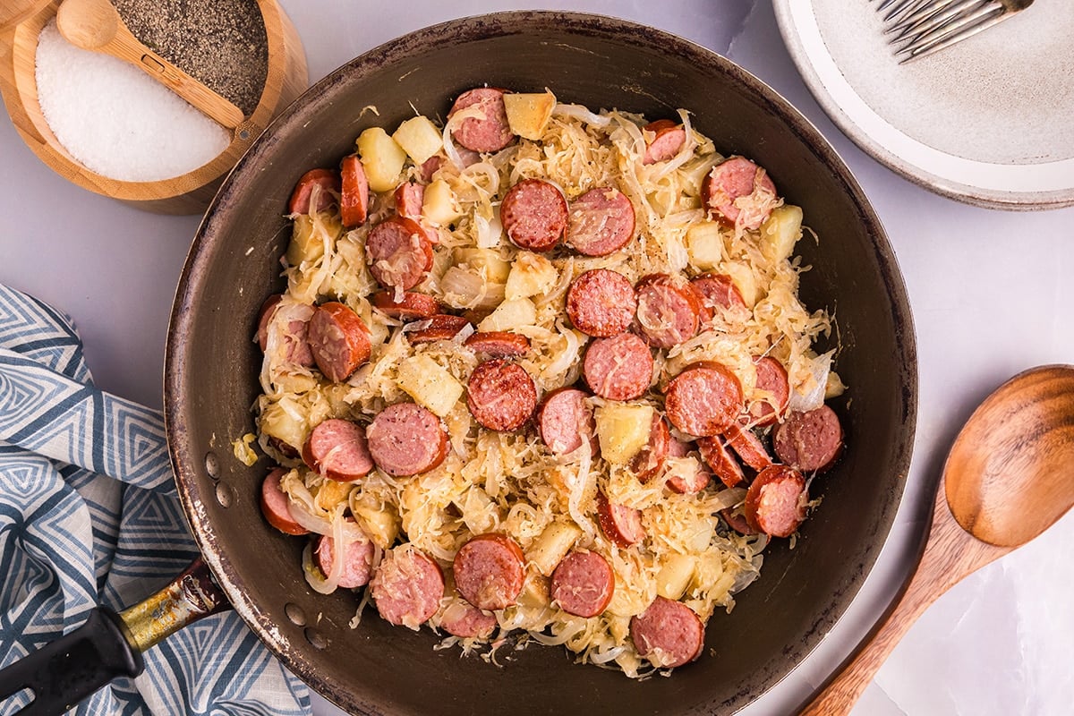 overhead shot of pork and sauerkraut in skillet