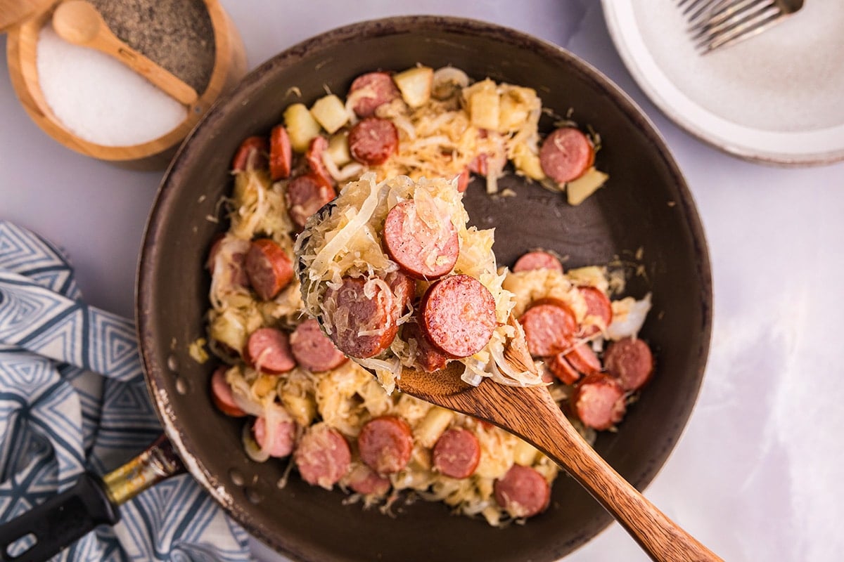 overhead shot of spoon full of sauerkraut and pork