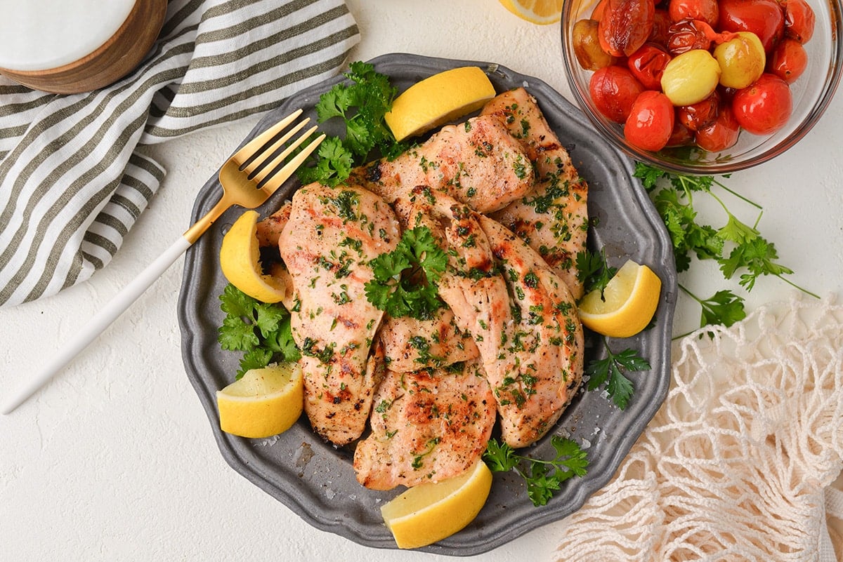 zoomed out shot of grilled chicken on a plate