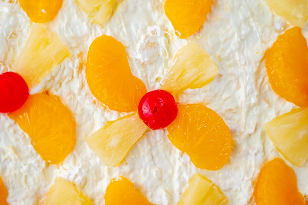 close up of cherry and pineapple on top of sunshine cake