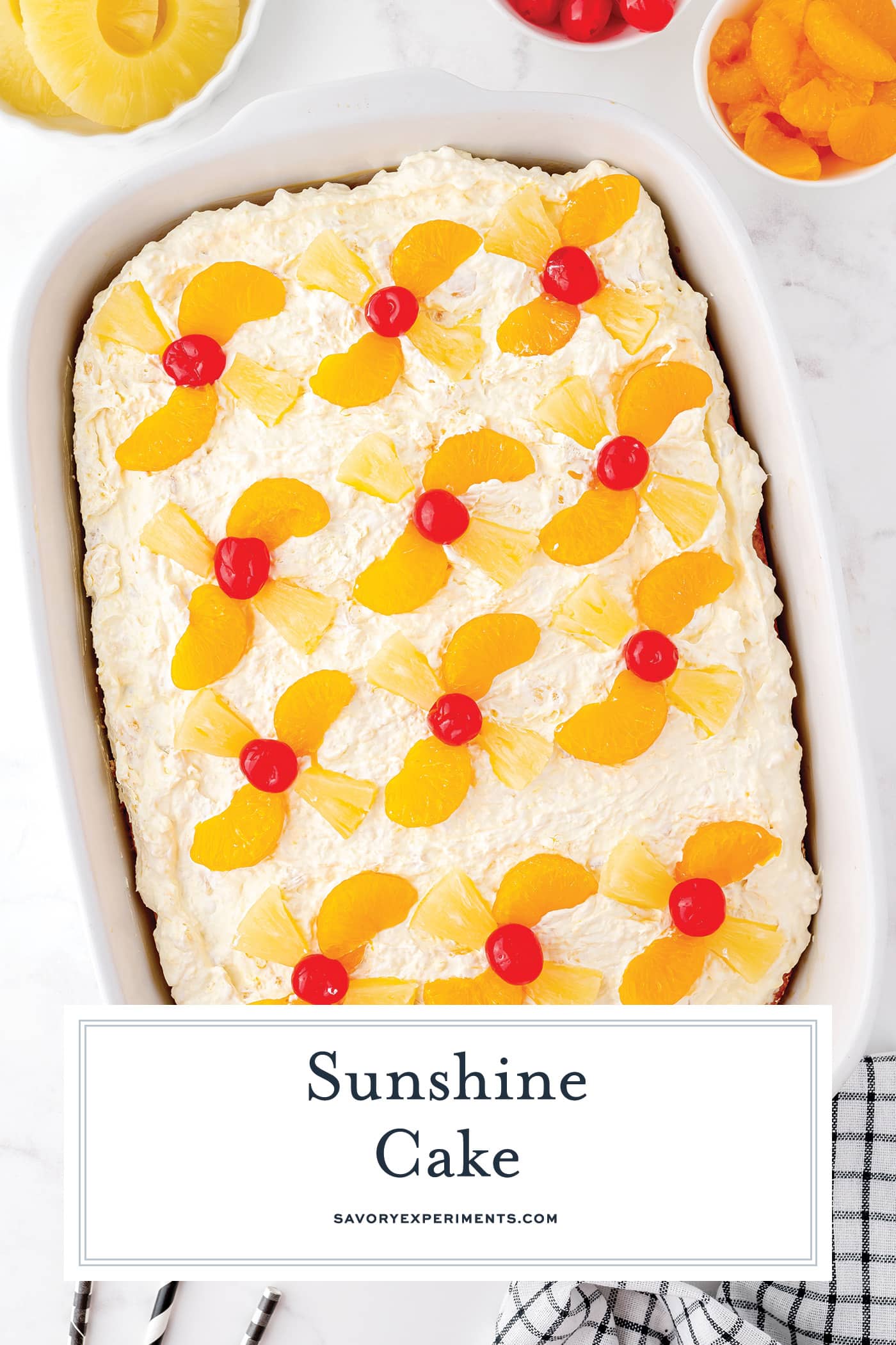 overhead shot of angled sunshine cake in a pan with text overlay for pinterest