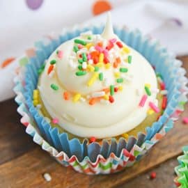 vanilla cupcake with white frosting and sprinkles