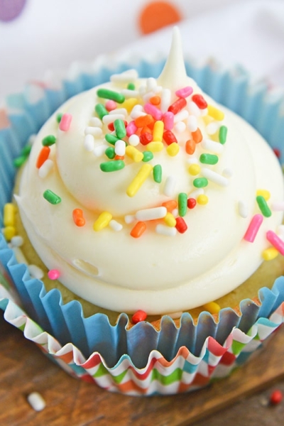 vanilla cupcake with white frosting and sprinkles