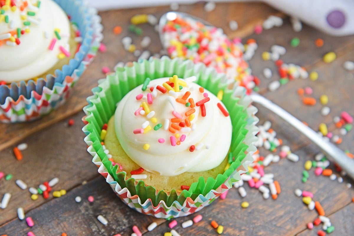 vanilla cupcakes with homemade frosting and rainbow sprinkles