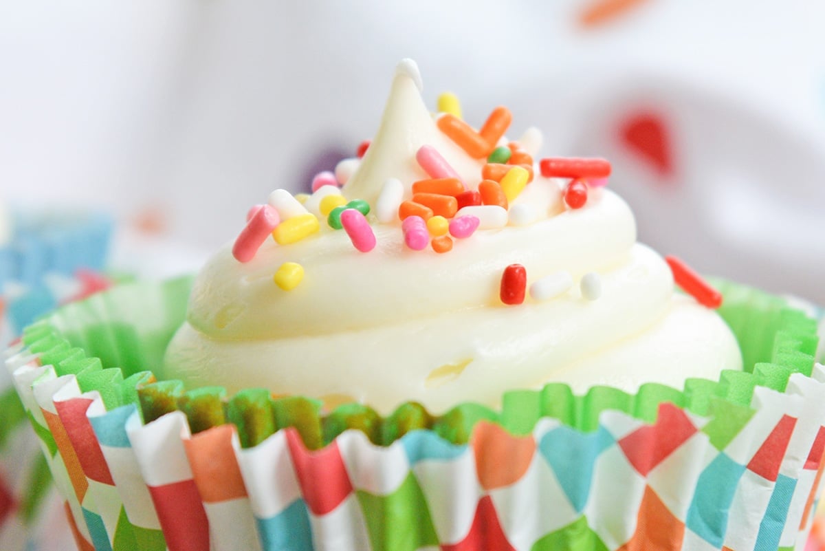 close up of cupcake with frosting and sprinkles