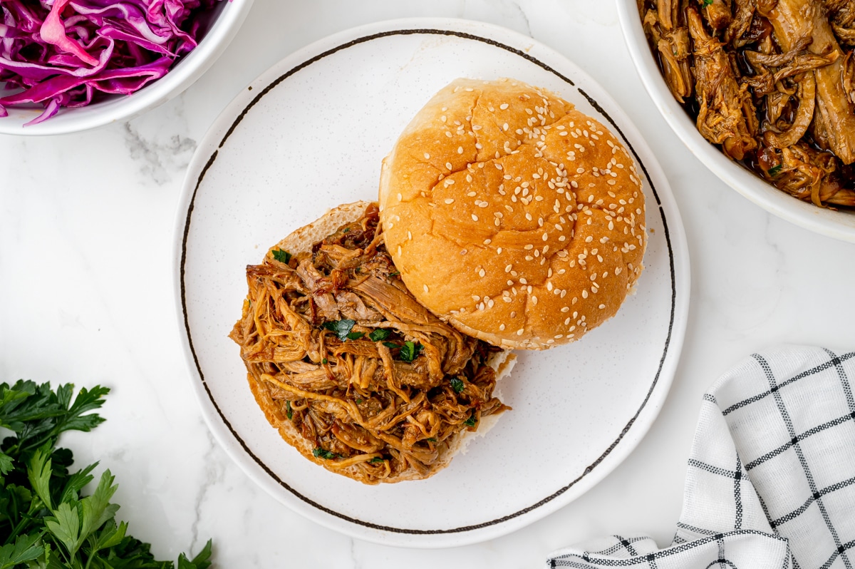 overhead shot of instant pot pulled pork on a bun