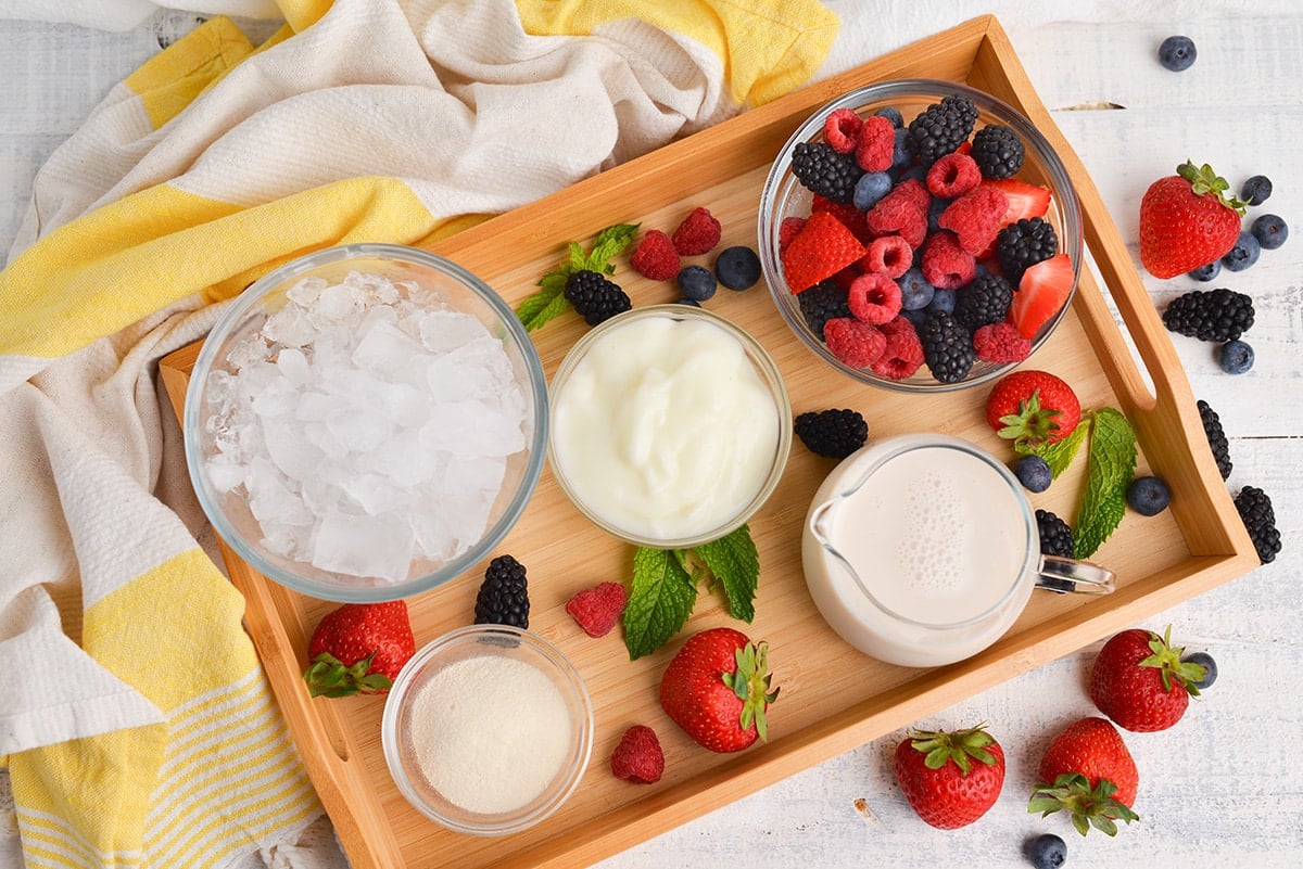 overhead shot of berry smoothie ingredients on a tray