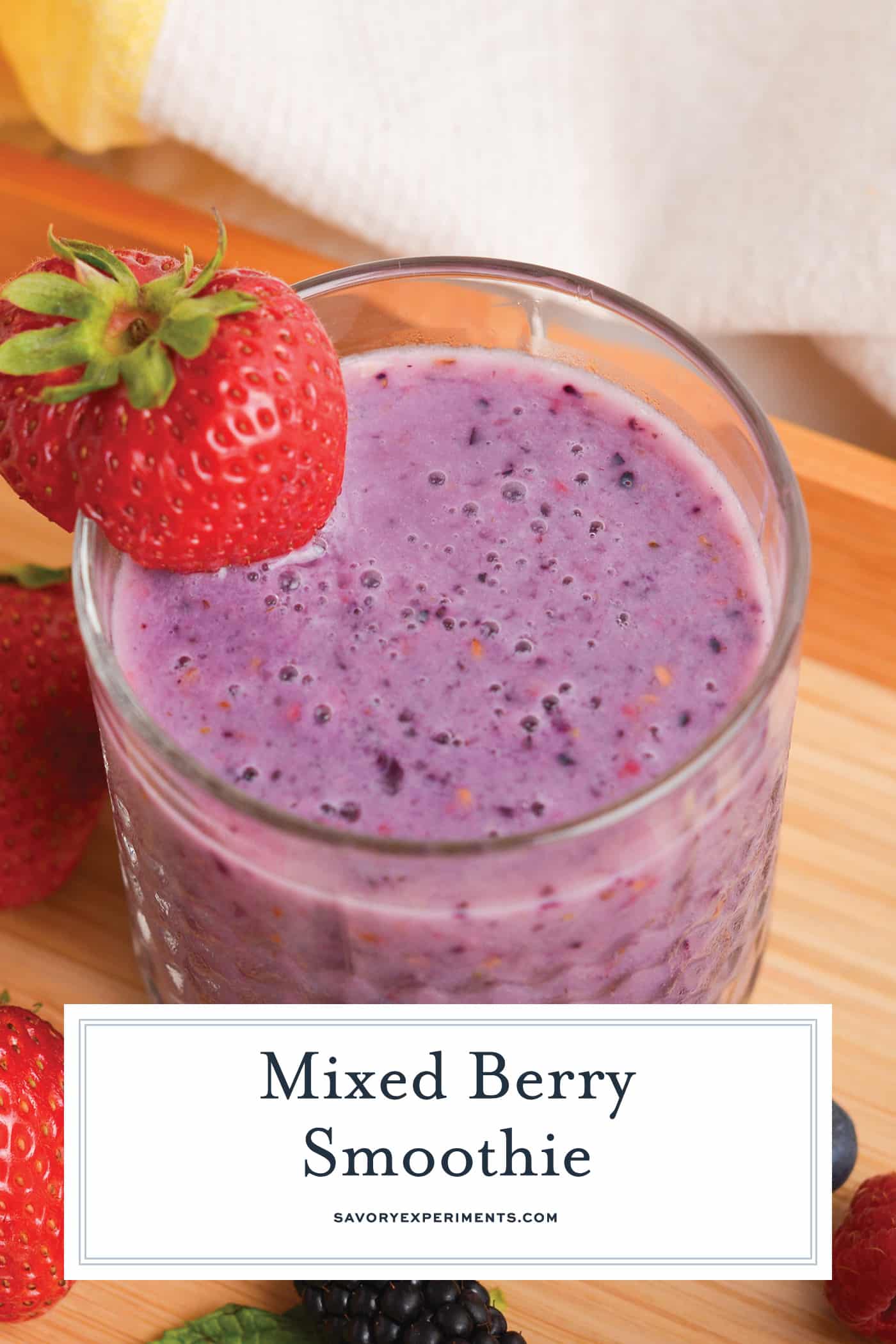 angled shot of berry smoothie with text overlay for pinterest