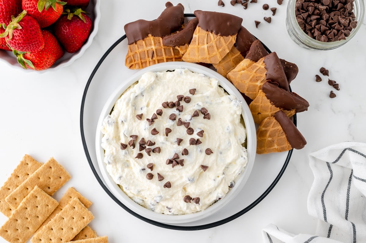 overhead shot of bowl of cannoli dip with chocolate dipped waffle cone pieces