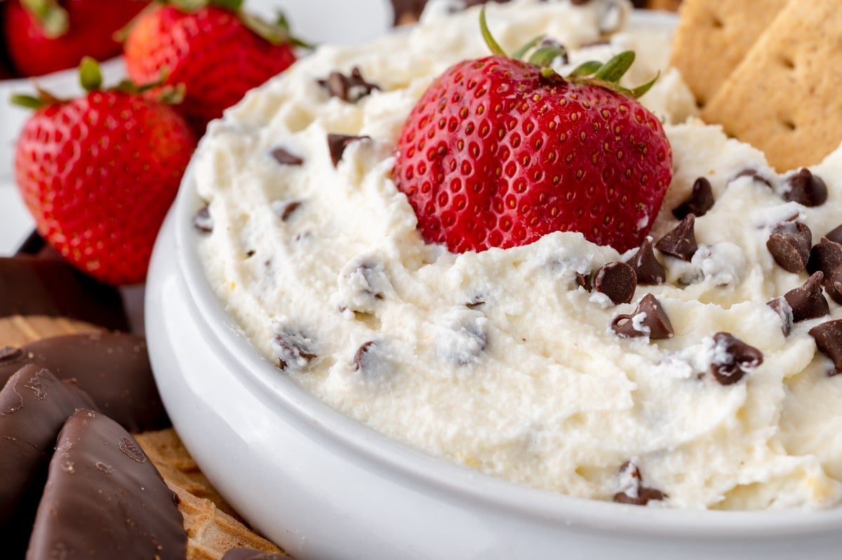 close up of strawberry in chocolate chip dip