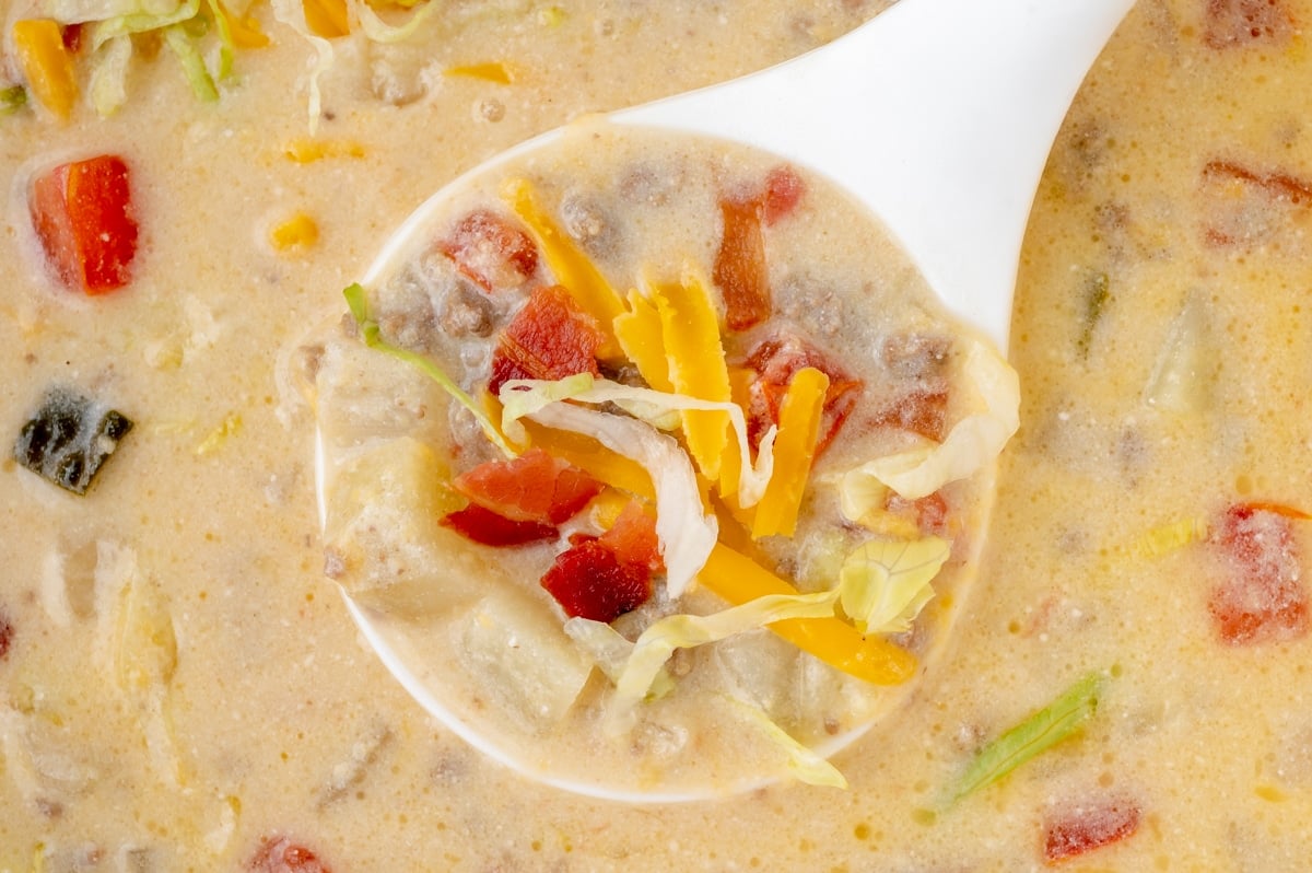 close up of ladle in pot of soup