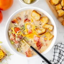 overhead shot of cheeseburger soup with spoon in bowl