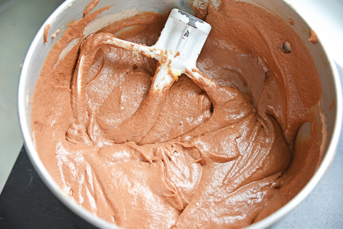bowl of chocolate cake batter with a paddle attachment