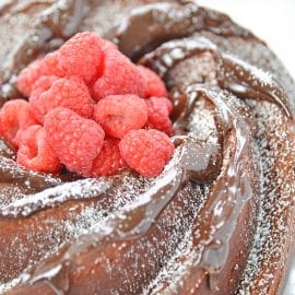 fresh raspberries in the center of a chocolate bundt cake