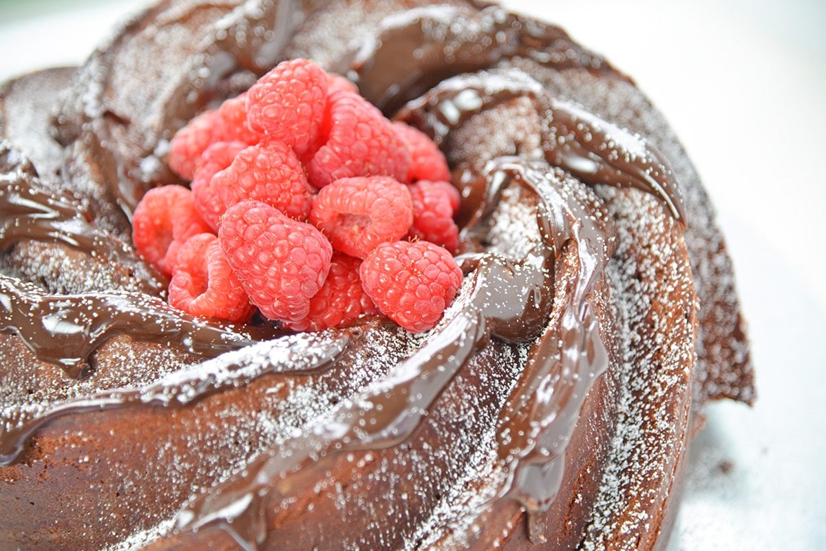 fresh raspberries in the center of a chocolate bundt cake