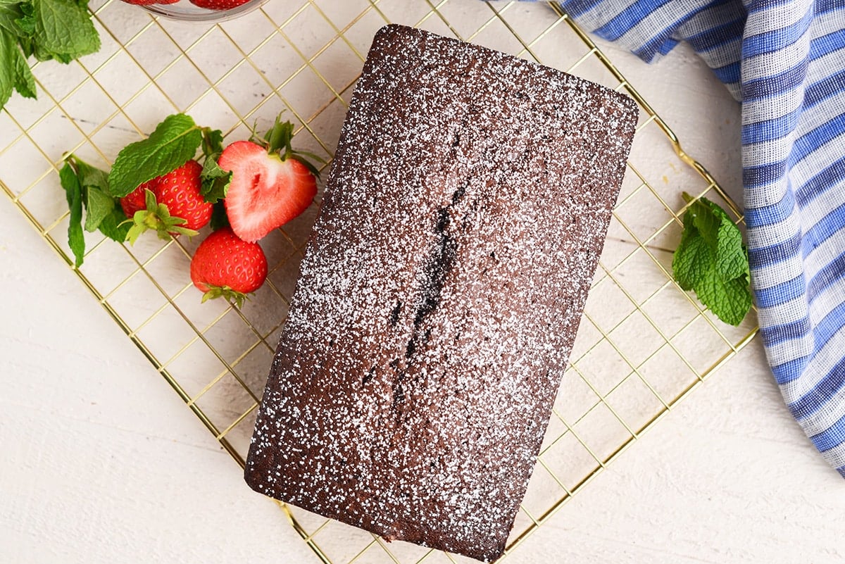 baked chocolate loaf cake on a cooling rack
