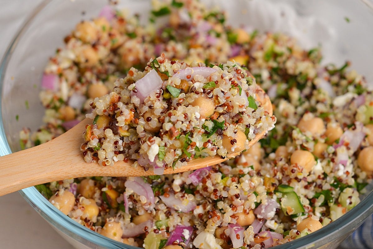 angled shot of jennifer aniston salad on wooden spoon