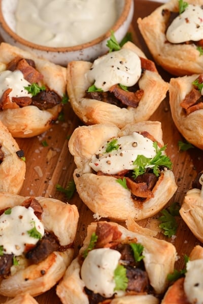 close up of mini beef wellington with dijon cream sauce topping