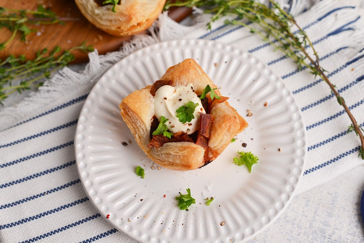 single beef wellington cup with parsley and cream sauce