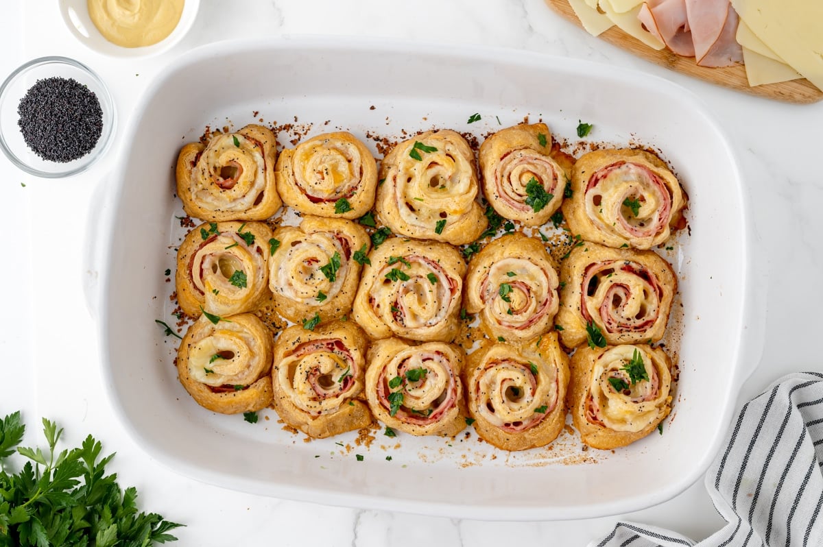 zoomed out overhead shot of baked ham and cheese pinwheels