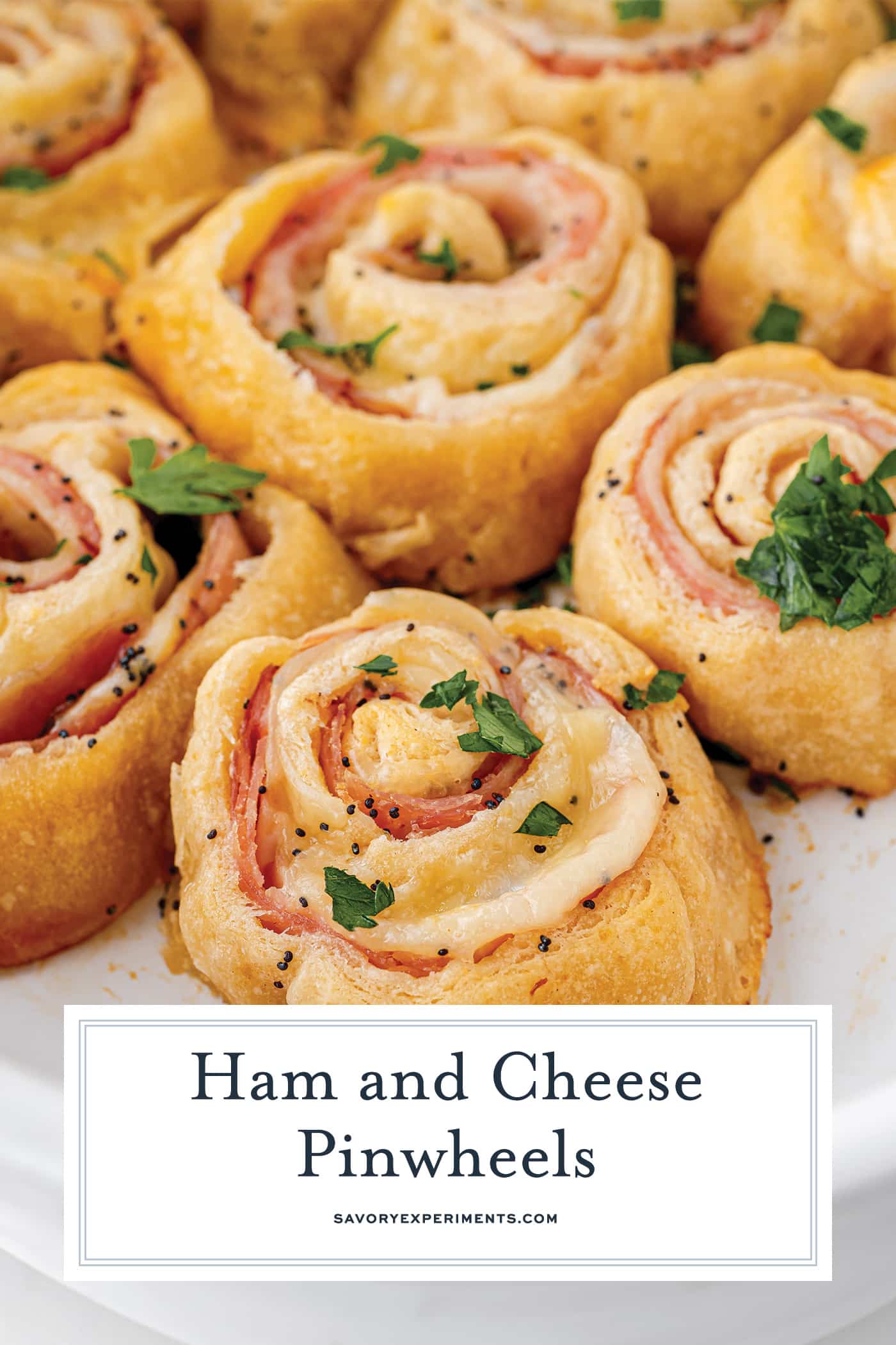 angled shot of ham and cheese pinwheels in baking dish with text overlay for pinterest