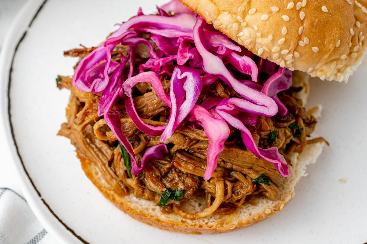 red cabbage slaw on pulled pork sandwich