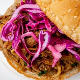 close up of red cabbage slaw on pulled pork sandwich