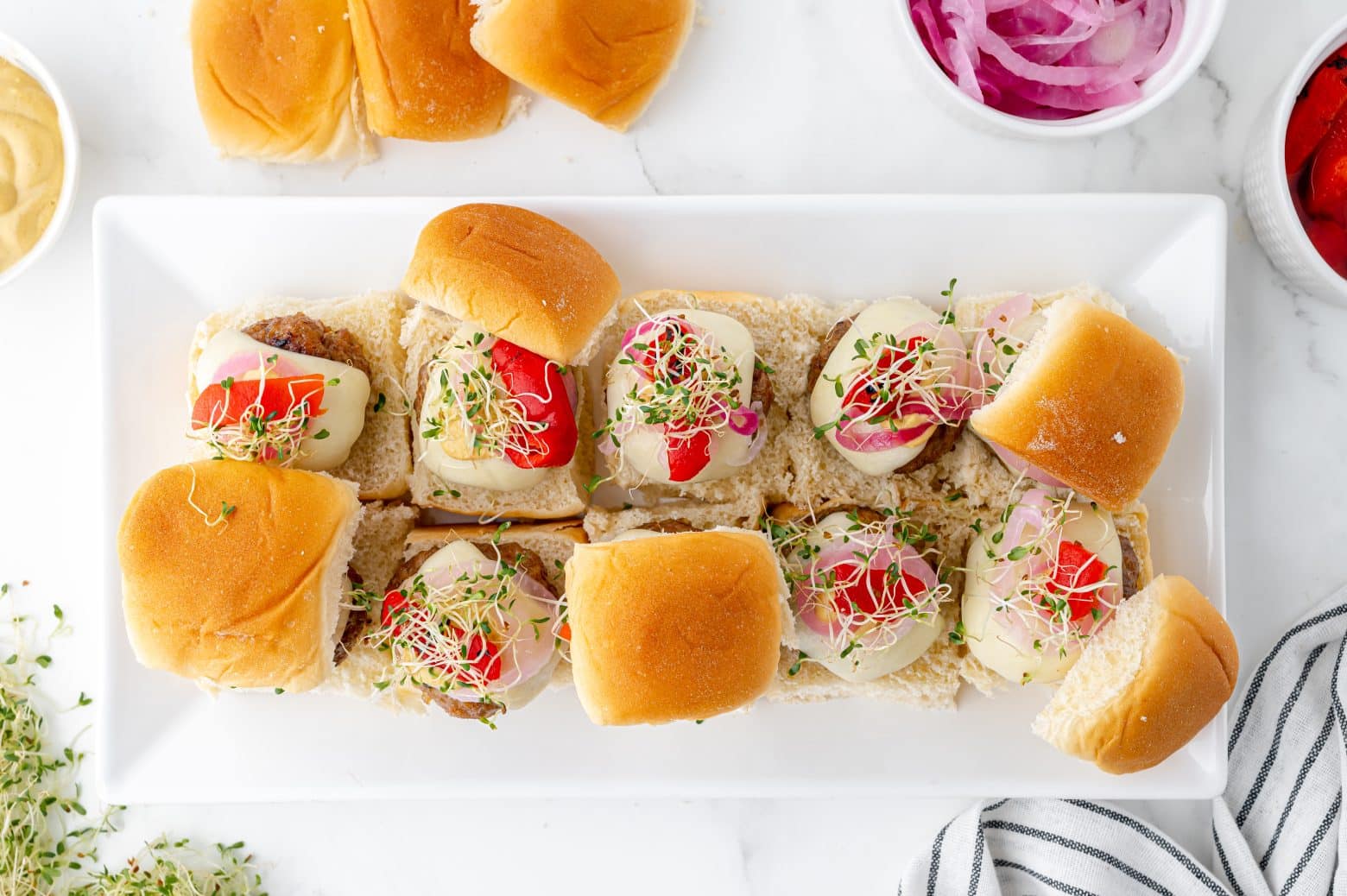 serving platter of sausage slider sandwiches