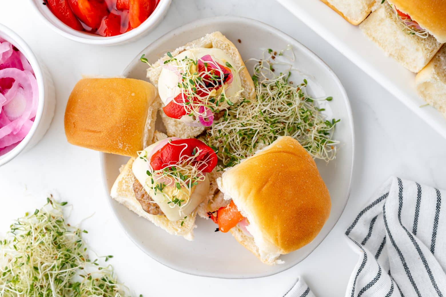 single plate with sausage sliders and alfalfa sprouts