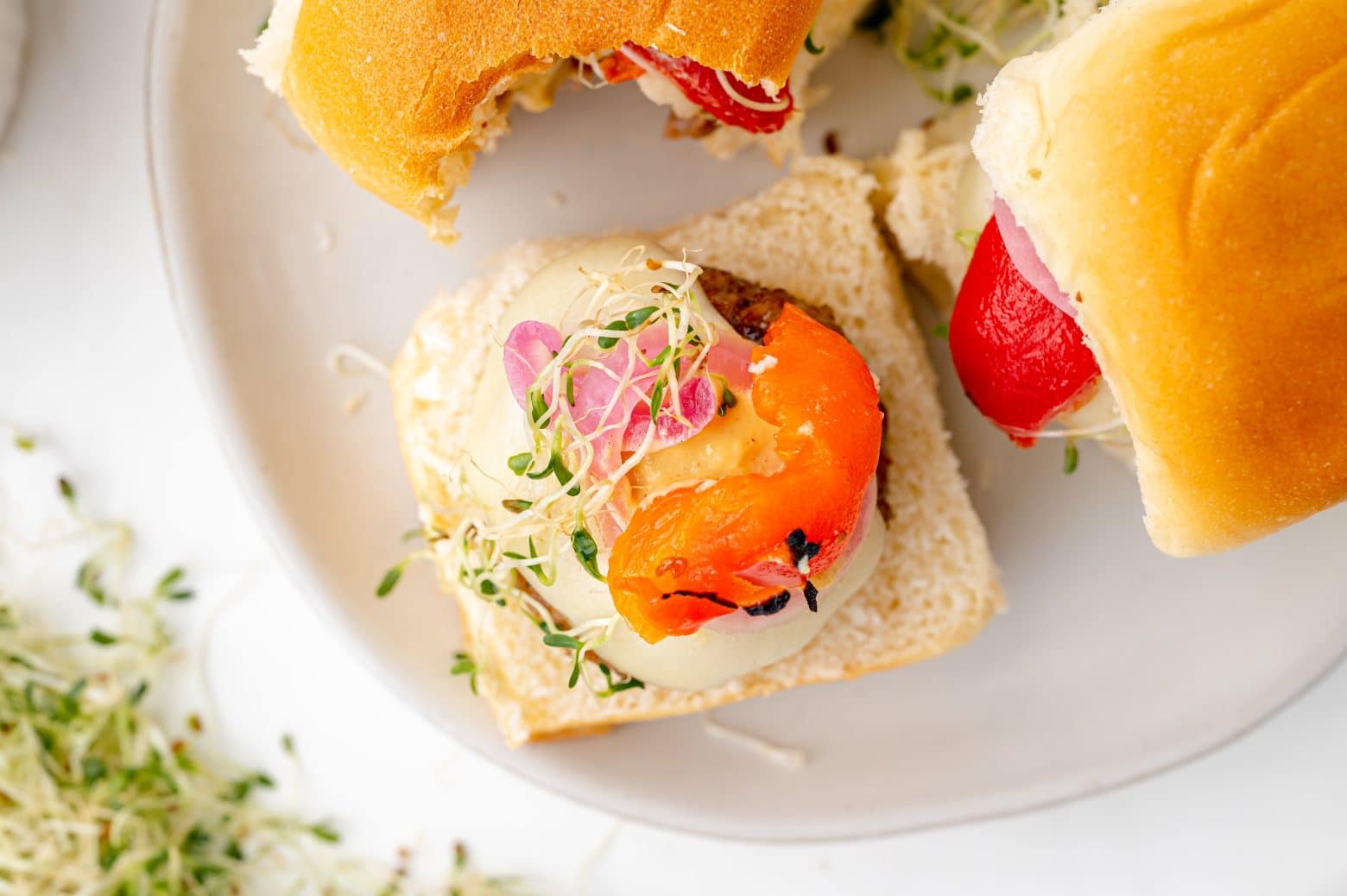 close up of sausage sandwich with toppings