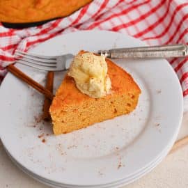 angled shot of slice of sweet potato cornbread topped with butter