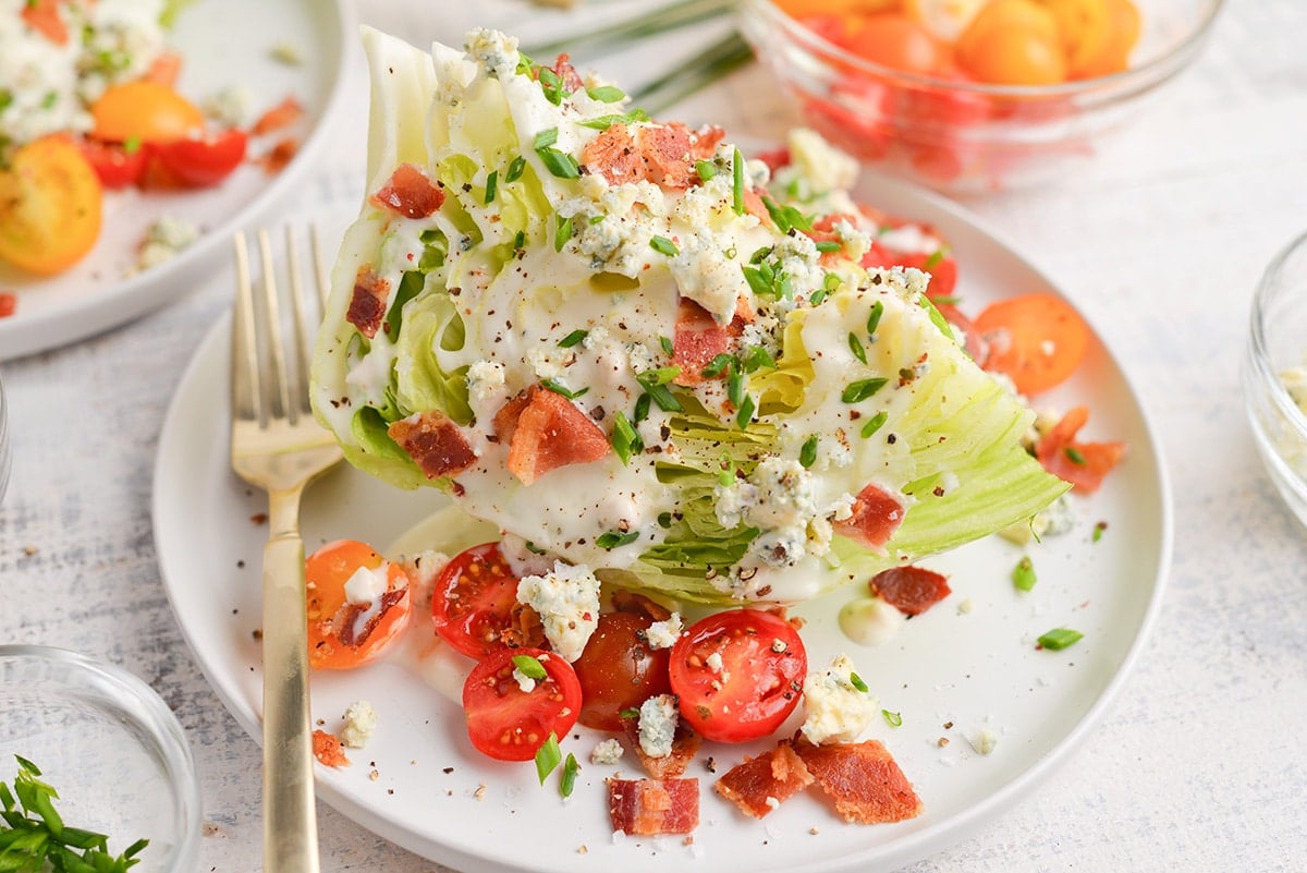 wedge of salad topped with dressing on plate