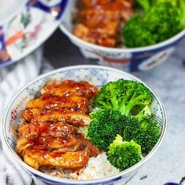 angled shot of two bowls of chicken rice bowls